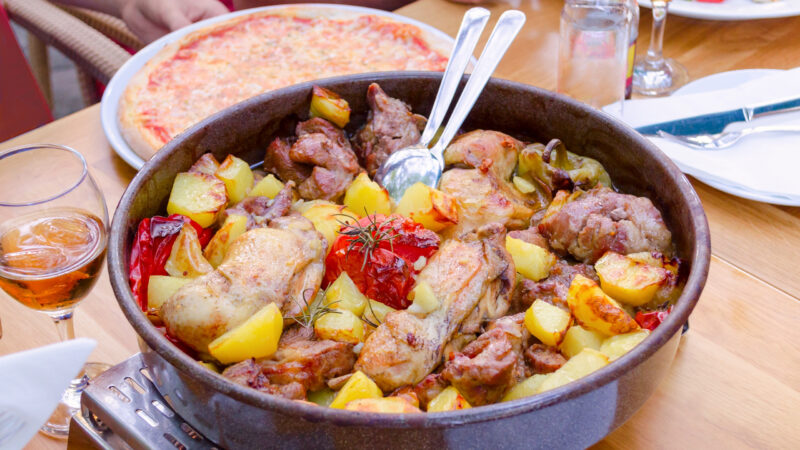 traditional croatian food peka with mix meat, vegetables and wine