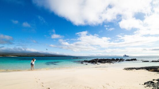 Lone traveller looking out over the clear azure waters of San Cristobal, the Galapagos