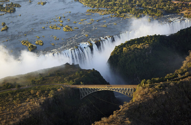 High angle view of Victoria Falls and a bridge during luxury Zambia holidays.