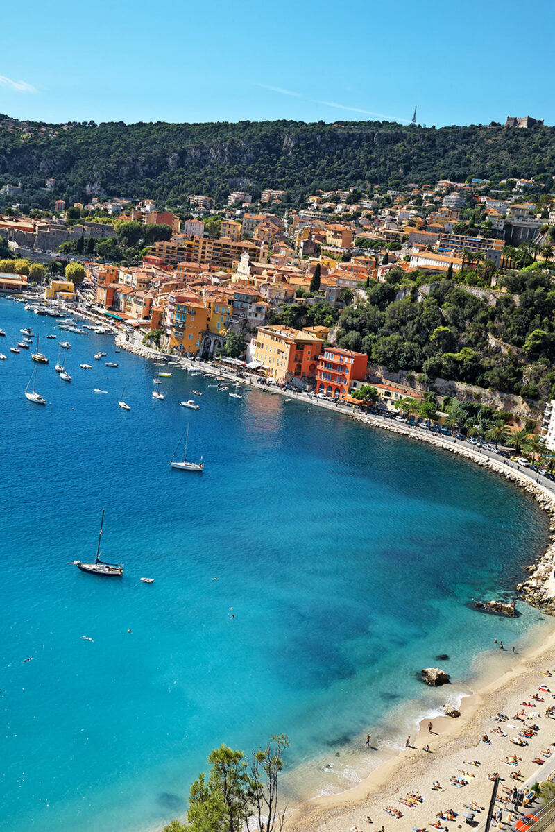 An overhead view of a blue bay and beach on the French Riviera during luxury France holidays.