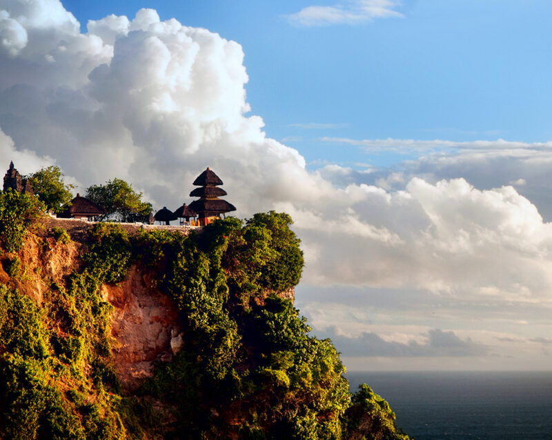 A Balinese temple perched on a high ocean cliff during luxury Bali tours.