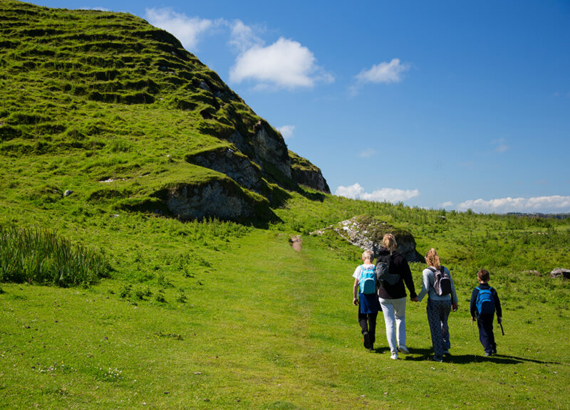 Beautiful green fields and hills of Ireland, hiking family with children