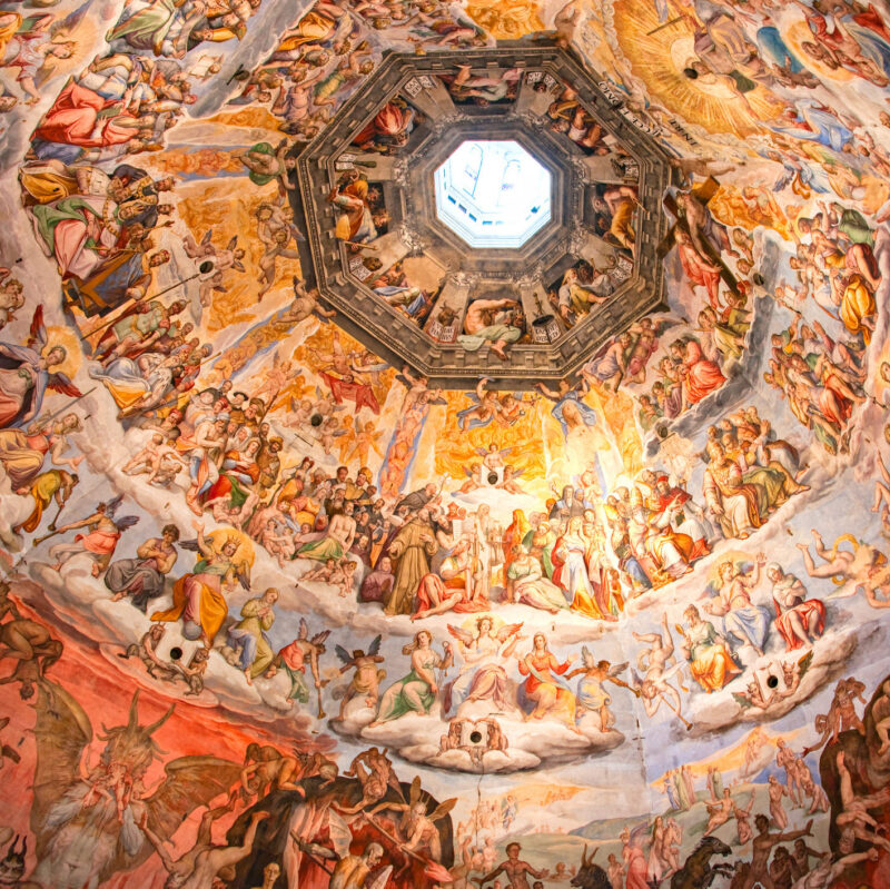 Ornate domed ceiling fresco with numerous figures and an octagonal lantern for luxury Tuscany vacations.