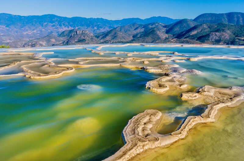 Turquoise mineral pools overlooking a mountain valley during luxury Latin America honeymoon holidays.
