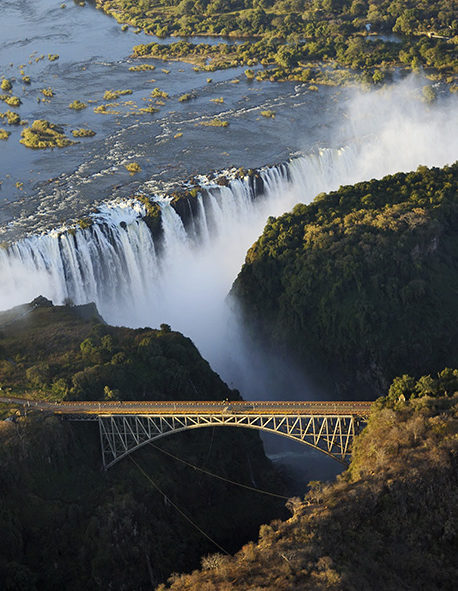 Aerial view of a bridge over a gorge near Victoria Falls during luxury South Africa rail travel.