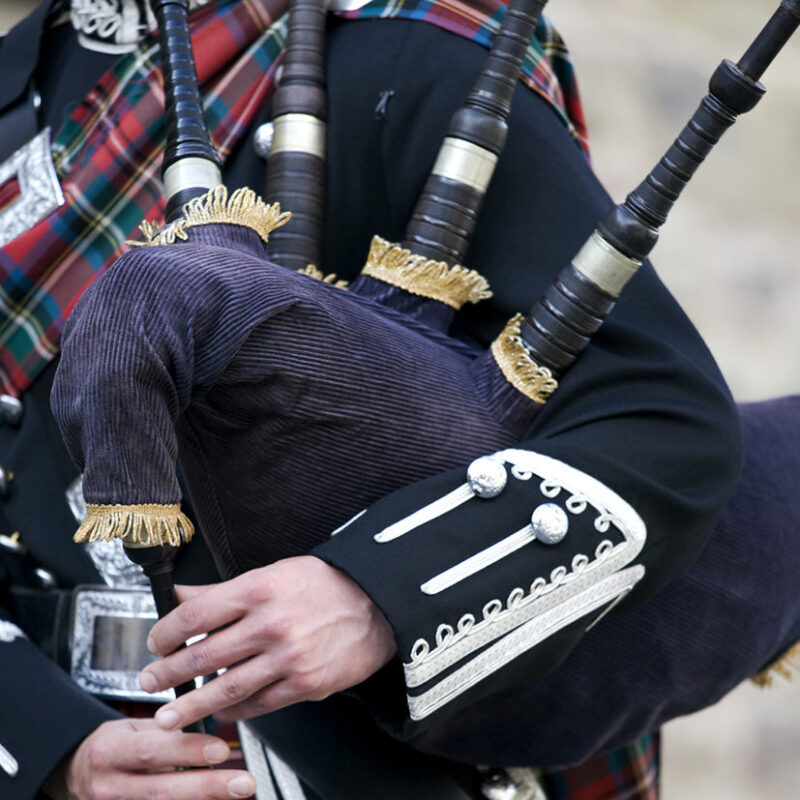 Luxury Grand Tours of Europe - Close-up mid section of a man playing the Scottish bagpipes