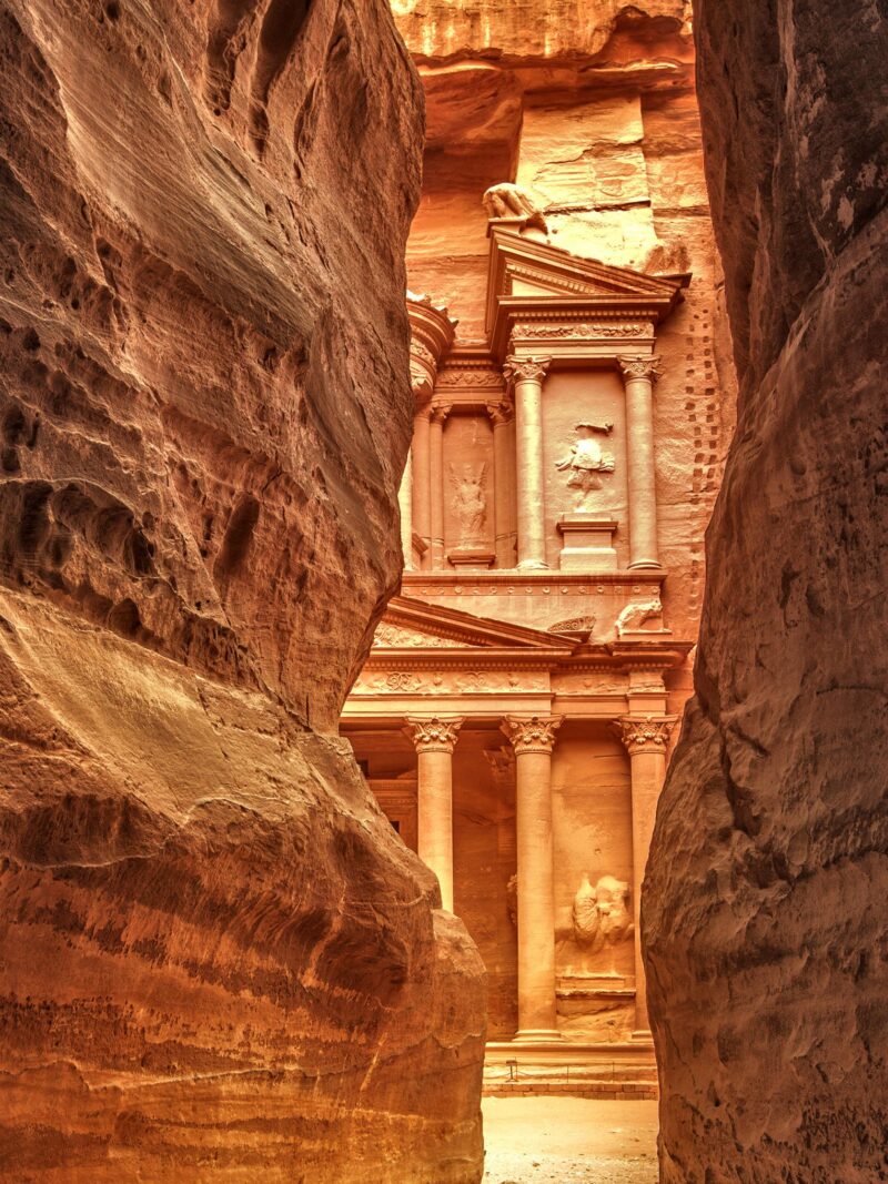 The Treasury at Petra seen through a narrow rock Siq during luxury grand tours and safaris.