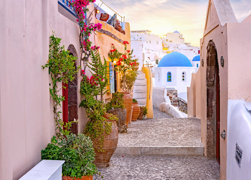 Narrow scenic street of Oia Village on Santorini Island at sunse ancient, wall, historic, flowers, sky, aegean, architecture, background, beautiful, blue, building, caldera, church, city, culture, cyclades, destination, europe, greece, greek, holiday, hotel, house, island, landmark, landscape, lifestyle, mediterranean, oia, romantic, santorini, style, summer, tourism, town, traditional, travel, vacation, view, village, white, street, mykonos, old, door, outdoor, scenery, evening, famous, sunset, Flagstone, Path, Pavement, Sidewalk, Walkway Narrow scenic street of Oia Village on Santorini Island at sunset, Greece..ancient, wall, historic, flowers, sky, aegean, architecture, background, beautiful, blue, building, caldera, church, city, culture, cyclades, destination, europe, greece, greek, holiday, hotel, house, island, landmark, landscape, lifestyle, mediterranean, oia, romantic, santorini, style, summer, tourism, town, traditional, travel, vacation, view, village, white, street, mykonos, old, door, outdoor, scenery, evening, famous, sunset