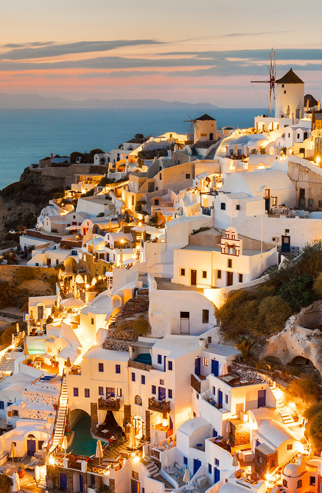 157742984 Cliff, D, Aegean Sea, Building Exterior, Built Structure, Color Image, Architecture, Building, Landscape, Nature, Outdoors, Scenery, Sea, Water Landscape view of the Oia at sunset, Santorini, Greece..157742984.Aegean Sea, Building Exterior, Built Structure, Cliff, Color Image, Dusk, Europe, Famous Place, Greece, High Angle View, High Up, Hill, Horizontal, Illuminated, Landmarks, Light, Mountain, Night, Nobody, Oia, Outdoors, Santorini, Sea, Sunset, Tourism, Tourist Resort, Traditional Culture, Travel, Travel Destinations, Travel Locations, Twilight, Water, Water’s Edge, White, Wide-Angle Lens, Windmill.Greece