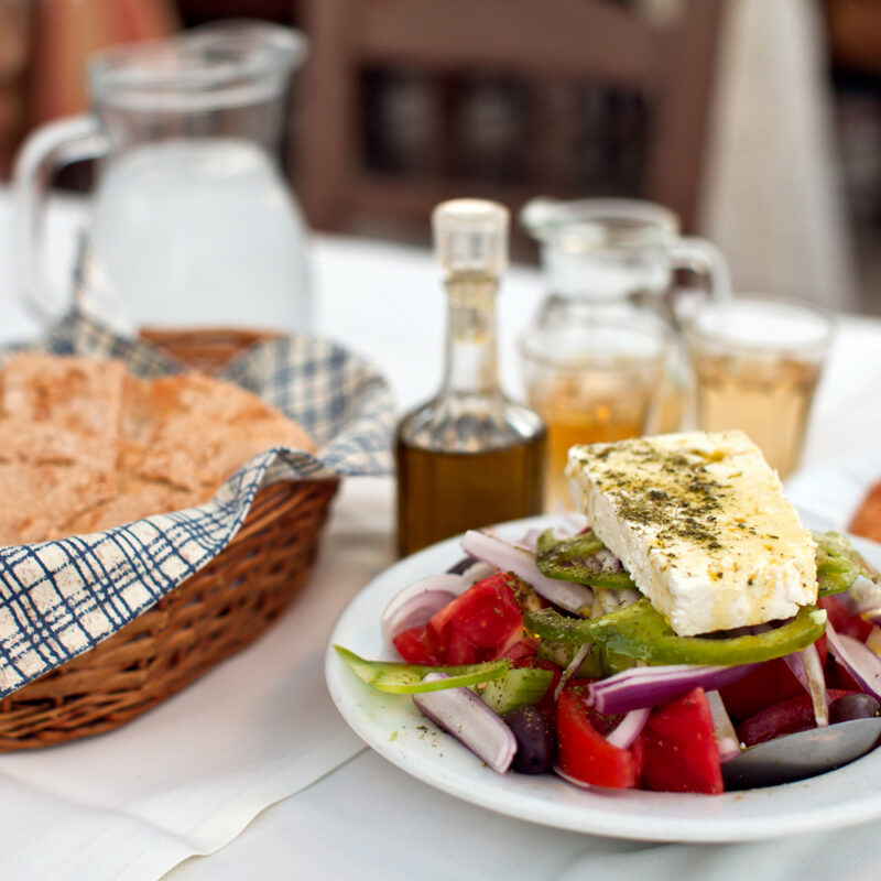 Greek salad with country bread and home made white wine in greek taverna.185841735.Aegean Sea, Arranging, Bar, Bread, Carafe, Cheese, Classical Greek, Cooking Oil, Cyclades Islands, Dining, Eating, Feta Cheese, Food, Glass, Greece, Greek Culture, Greek Salad, Healthy Eating, Healthy Lifestyle, Homemade Bread, Island, Journey, Kitchen Knife, Landscape, Lemon, Lettuce, Mykonos, Non-Urban Scene, Olive, Olive Oil, Onion, Outdoors, Pepper, Pepper, Pepper Shaker, Restaurant, Rural Scene, Saganaki, Salad, Salt, Salt Shaker, Santorini, Scenics, Table, Tomato, Tourism, Traditional Culture, Travel, Vinegar, Water, White, Wine, cold water, grilled cheese.Greece 185841735 Arranging, Bar, Bread, Carafe, Cheese, Coo, Aegean Sea, Classical Greek, Dish, Food, Meal