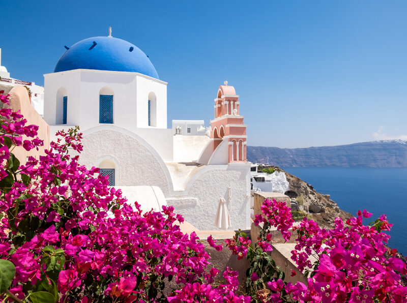 506042108 Beautiful, Cupola, Tourism, Holiday, Beauty, Mediterranean Countries, Architecture, Blossom, Building, Dome, Flower, Geranium, Plant Scenic view of traditional cycladic houses with flowers in foreground, Oia village, Santorini, Greece.506042108.Beautiful, Cupola, Mediterranean Countries, Tourism, Holiday, Beauty In Nature, Oia, Mill, Dusk, Honeymoon, Greek Culture, Bell Tower – Tower, Beauty, Scenics, Classical Greek, Romance, Multi Colored, White, Blue, Cultures, Famous Place, Architecture, Travel Destinations, Vacations, Nature, Santorini, Cyclades Islands, Greece, Europe, Sunset, Summer, Island, Hill, Landscape, Sky, Aegean Sea, Mediterranean Sea, Sea, Dome, Roof, House, Windmill, Church, Built Structure, Cityscape, Village, Town, Tourist Resort, Mediterranean Culture.Greece