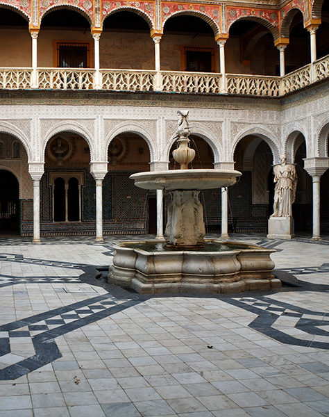 A marble fountain anchors the central courtyard in Italy, Rome