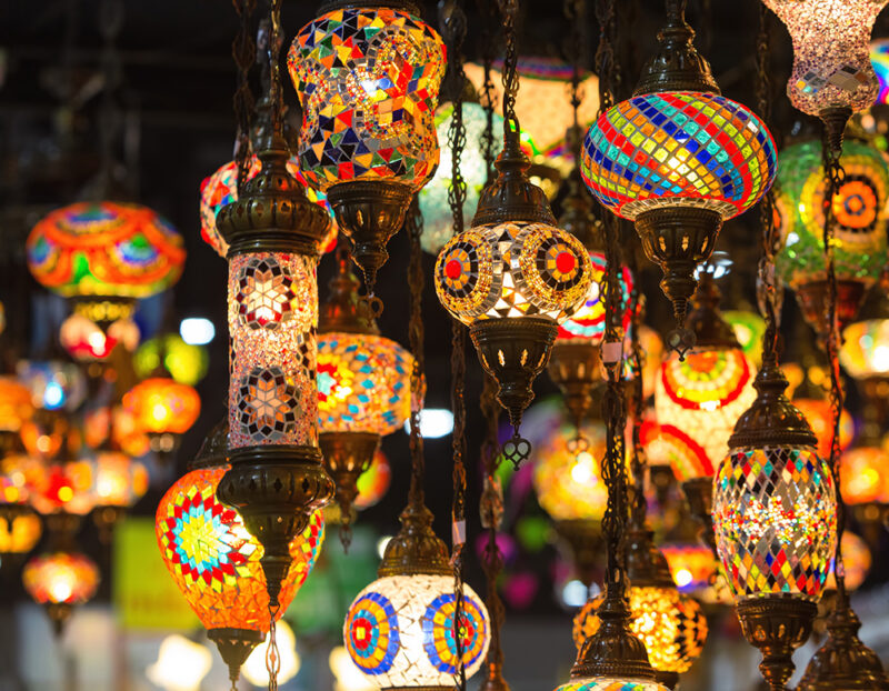 Intricate glass lanterns glow inside a souk – hand-crafted details brought to light by local artisans.