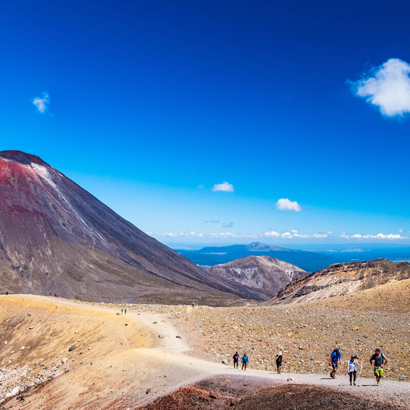 Group of hikers walking along a desert mountain trail during luxury adventure trips.