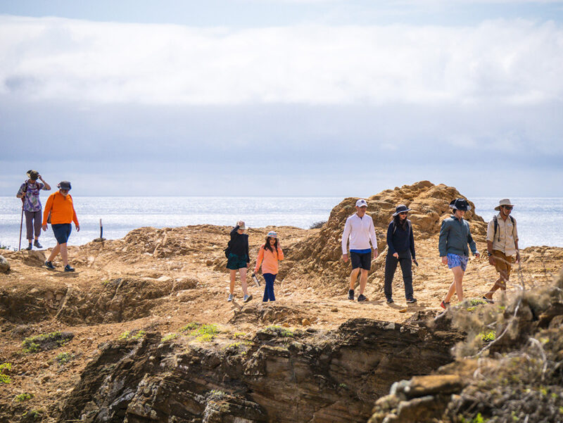 people hiking at the coast while on a luxury latin America vacation