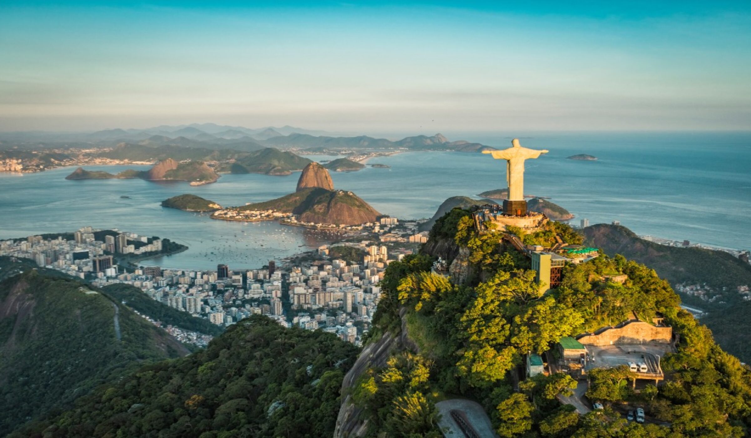 Panoramic of Christ the Redeemer, Rio de Janeiro, at golden hour set against the city and Guanabara Bay can be part of out luxury latin America tours