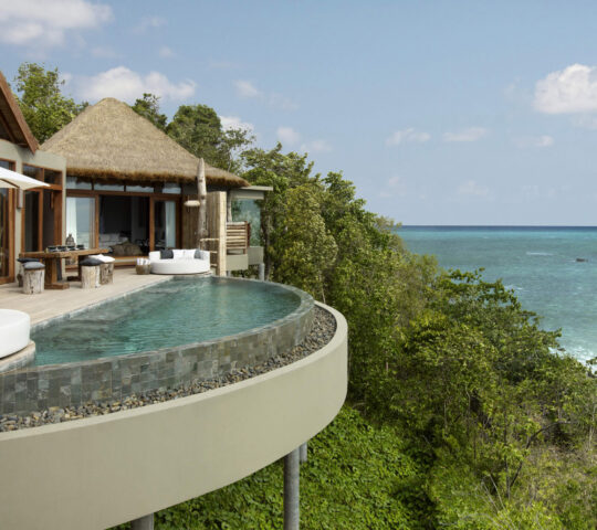 A luxurious private villa at Song Saa, featuring a stunning infinity pool overlooking crystal-clear ocean waters