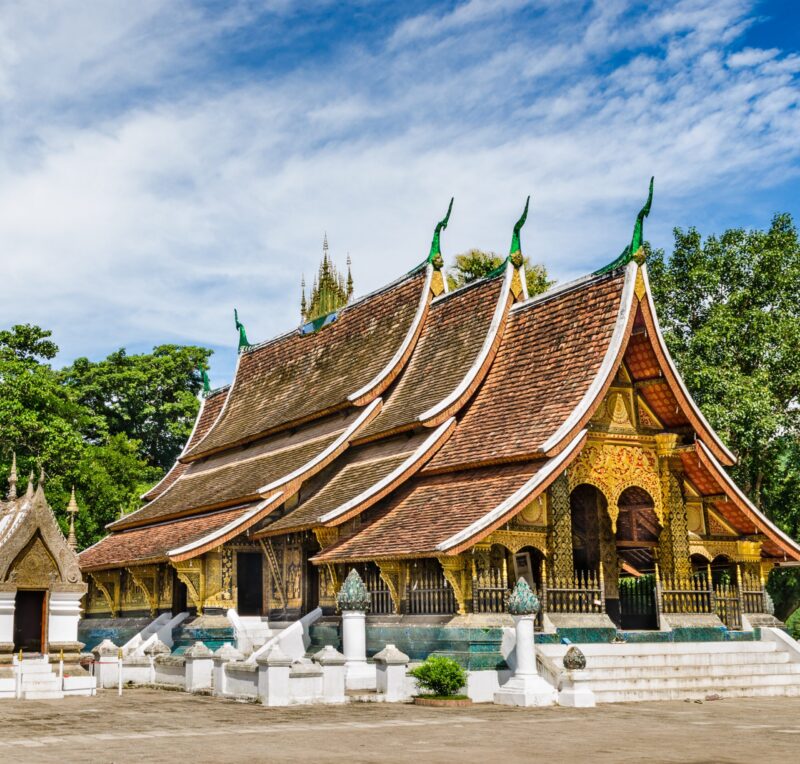 Ornate tiered roofs of Wat Xieng Thong temple in Luang Prabang, a stop on luxury Laos holidays.