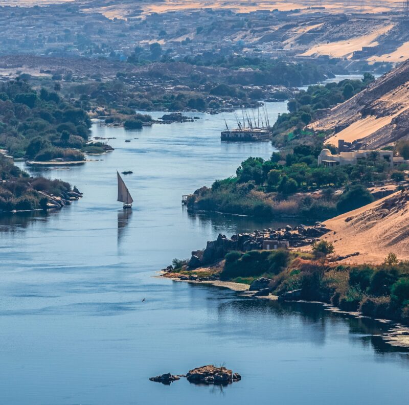 Sunset over the Nile River in the city of Aswan with sandy and deserted shores