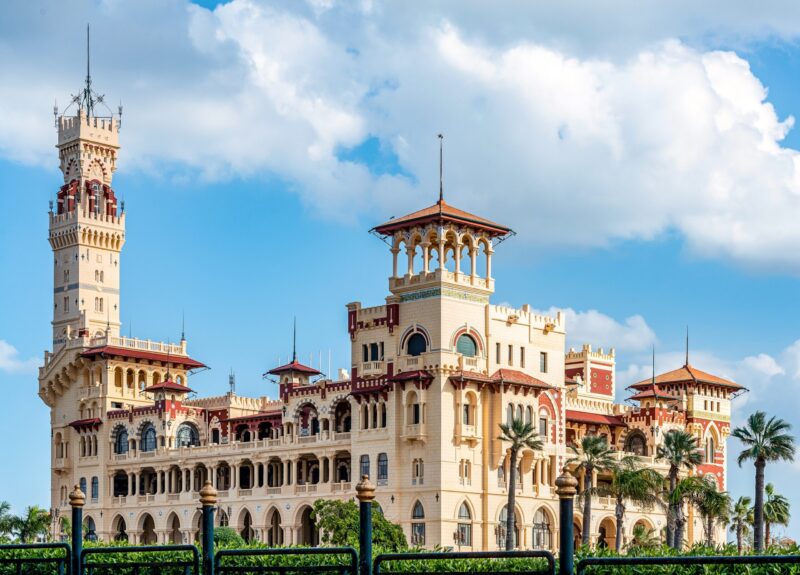 Royal Palace of the 1930s in Turkish and Florentine styles in a palm park on a sunny day.