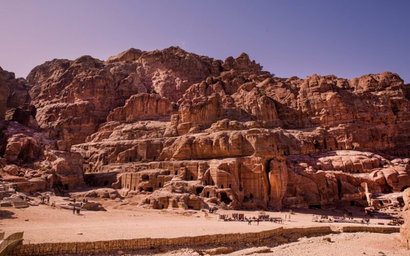 Ancient tombs and carved façades line the rugged sandstone cliffs along the Street of Facades in Petra, Jordan.