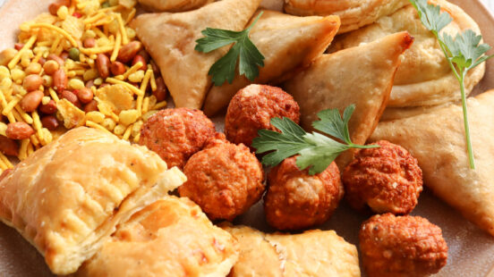 Snack platter of Cape Malay food, like samoosas, meatballs and mini pies