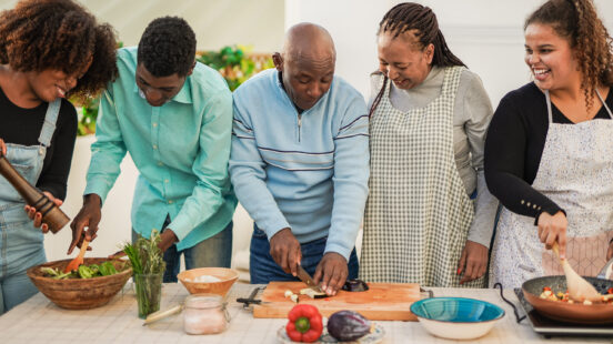 Family cooking a meal together in a kitchen