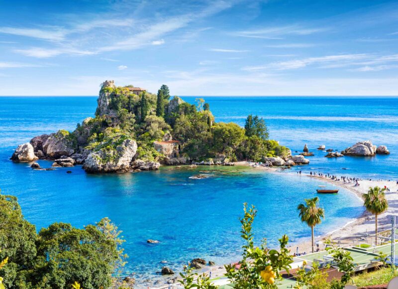 Isola Bella small island near Taormina, Sicily, southern Italy. Narrow path connects Isola Bella island to mainland Taormina beach surrounded by azure waters of the Ionian Sea.