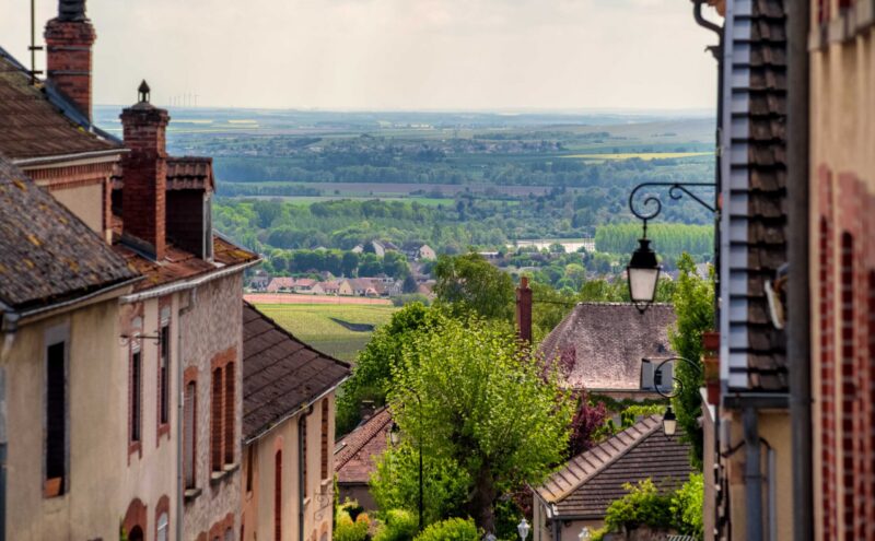 Brown roofs of village in Champagne region with marvellous view on vineyards and hills, summer France