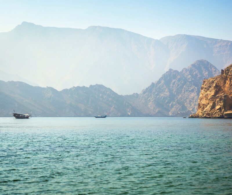 Charming view of the mountains and the sea in the haze near the Musandam arab, beach, beautiful, blue, boat, dhow, emirates, gulf, haze, horizon, khasab, landscape, middle east, mountain, musandam, ocean, oman, port, sand, sea, sky, summer, tourism, travel, vacation, water Charming view of the mountains and the sea in the haze near the Musandam, Oman