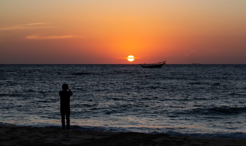 Arabian dhow in ocean at sunrise at Ras al Jinz in Oman dhow, boat, ocean, sea, water, sunrise, sky, nature, silhouette, coast, beautiful, ship, beach, landscape, background, horizon, orange, outdoor, sailboat, traditional, arabic, arabian, gulf, arab, red, outside, morning, arabia, shore, dawn, sun Arabian dhow in ocean at sunrise at Ras al Jinz, Oman