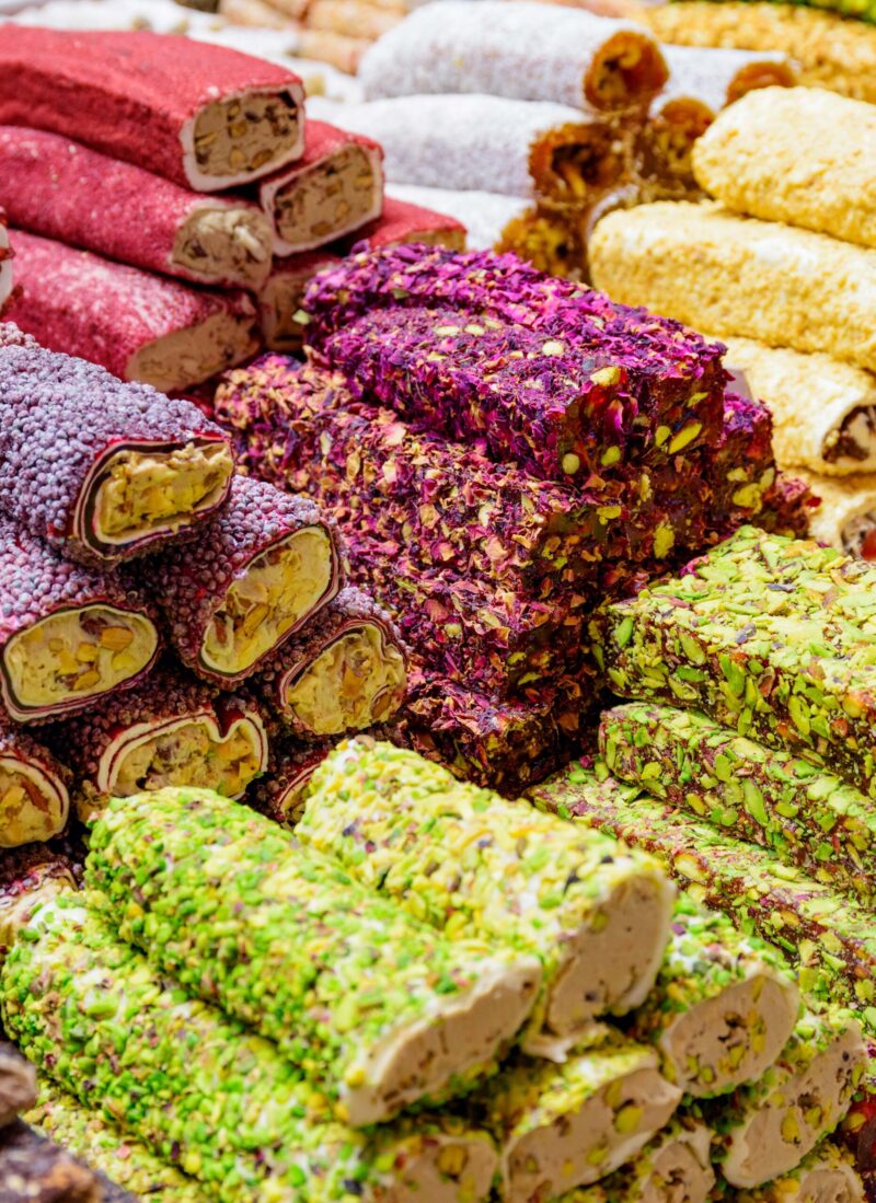 Various flavors of Turkish Delight rolls with nuts and flower petals on luxury Turkey Asia tours.