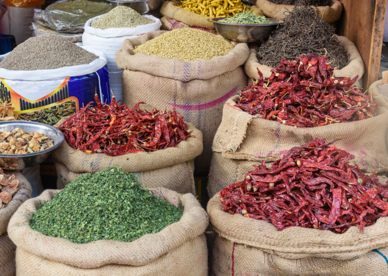 Bags and sacks with spices, seeds, roots for sale at local market in Bikaner. Rajasthan.