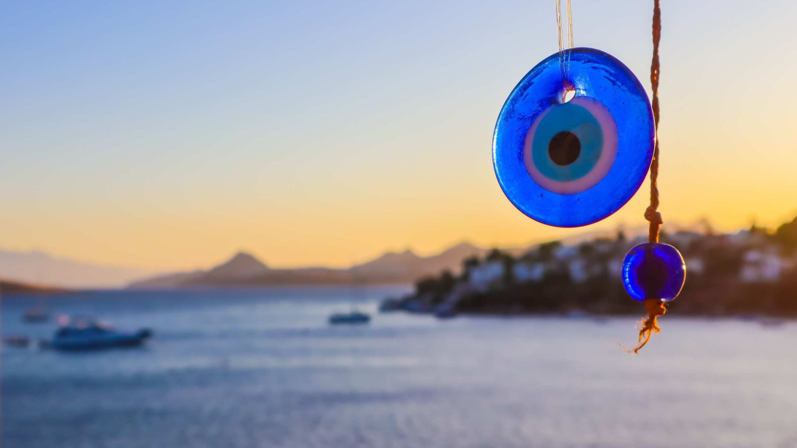 Blue Evil eye amulet on the background of a beautiful seascape
