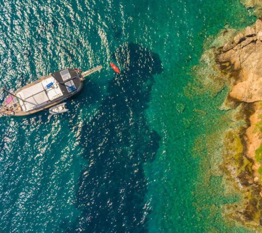 A gulet floats on turquoise waters