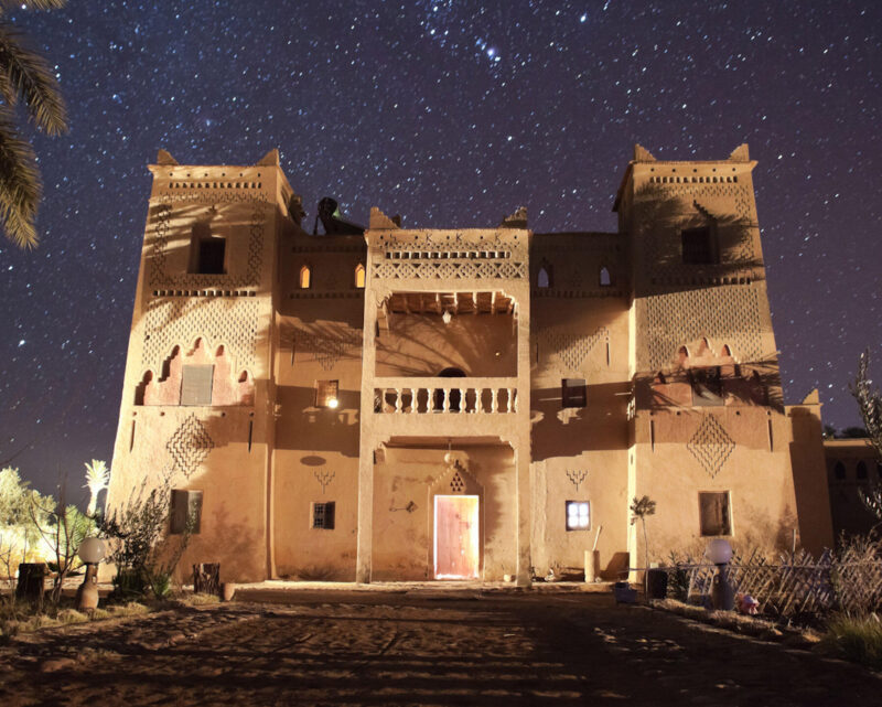A Moroccan Kasbah at night with stars in the night sky.Horizontal composition.