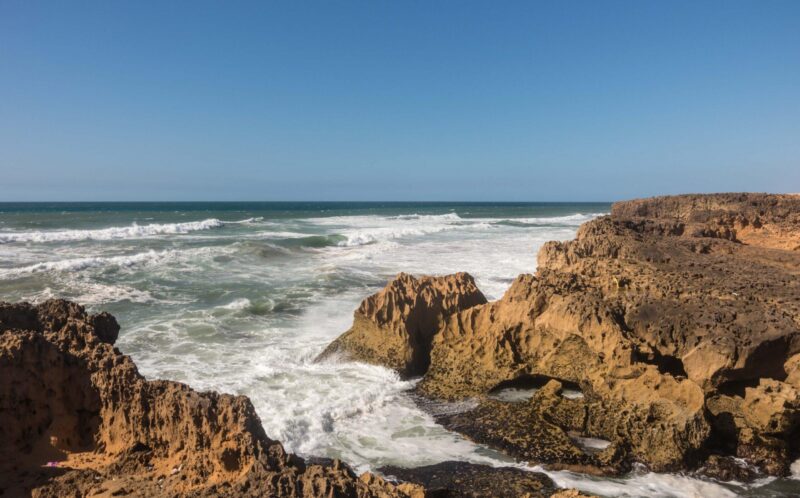 Waves breaking of cliffs near Oualidia lagoon in same name village in Atlantic ocean coast, Morocco