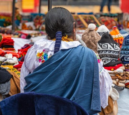 A lady in traditional dress at Otavalo market