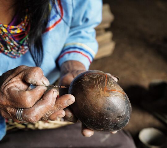 Amazonian woman painting mokawas