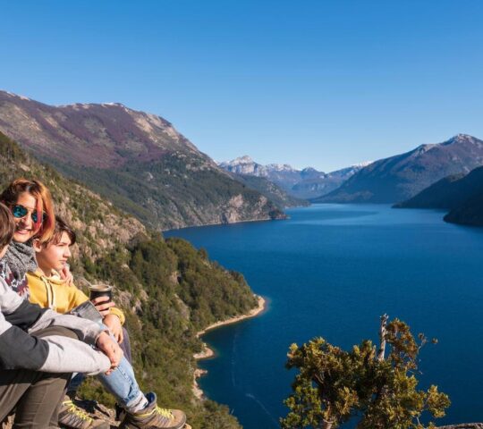 A family enjoy a stunning viewpoint in the Lake District