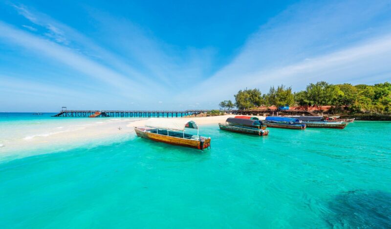 colorful exotic seascape with boats near Zanzibar shore in Africa