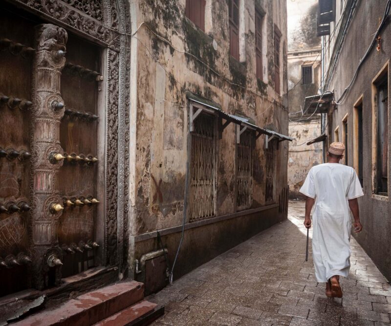 islamic man walking through narrow streets of Stonetown