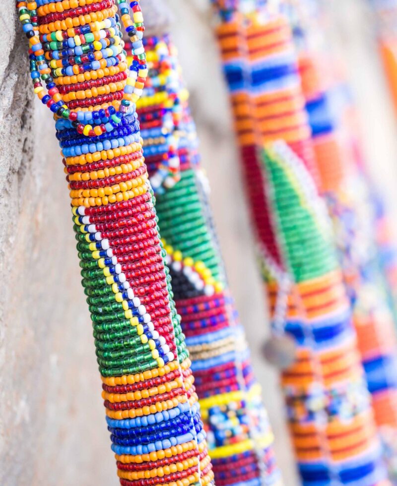 Maasai rungu (club) decorated with beads and sold as a souvenir at a local Maasai Market. Close up.
