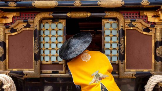 Japanese man wearing traditional clothes during annual Takayama festival.