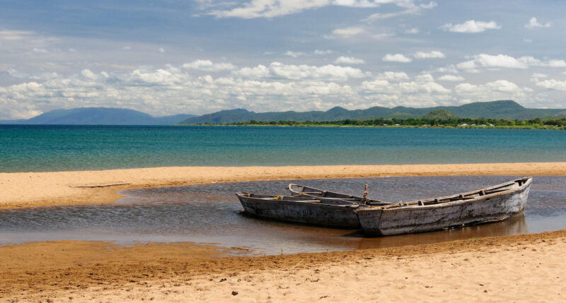 Tanzania, Tanganyika lake is the Worlds longest and second deepest fresh water lake, it is also one of the oldest lakes on the planet. The picture presents beautiful sand beach and traditional boats