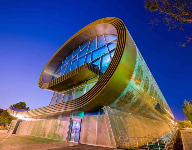 Glowing at dusk, Baku's Carpet Museum forms a rolled rug – woven heritage in Azerbaijan.