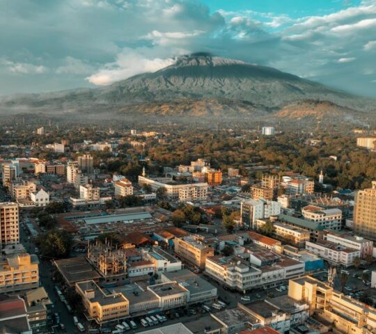 The city of Arusha with Mount Kilimanjaro looming behind