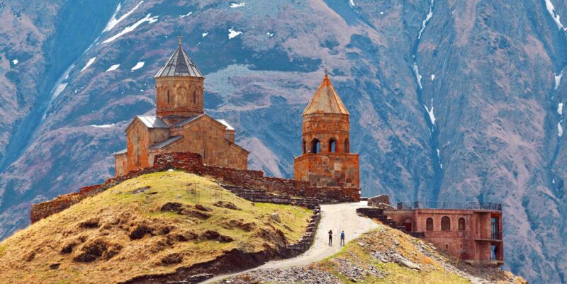 Gergeti Trinity Church stands on a hilltop below the rugged peaks of Mount Kazbeg in Georgia.