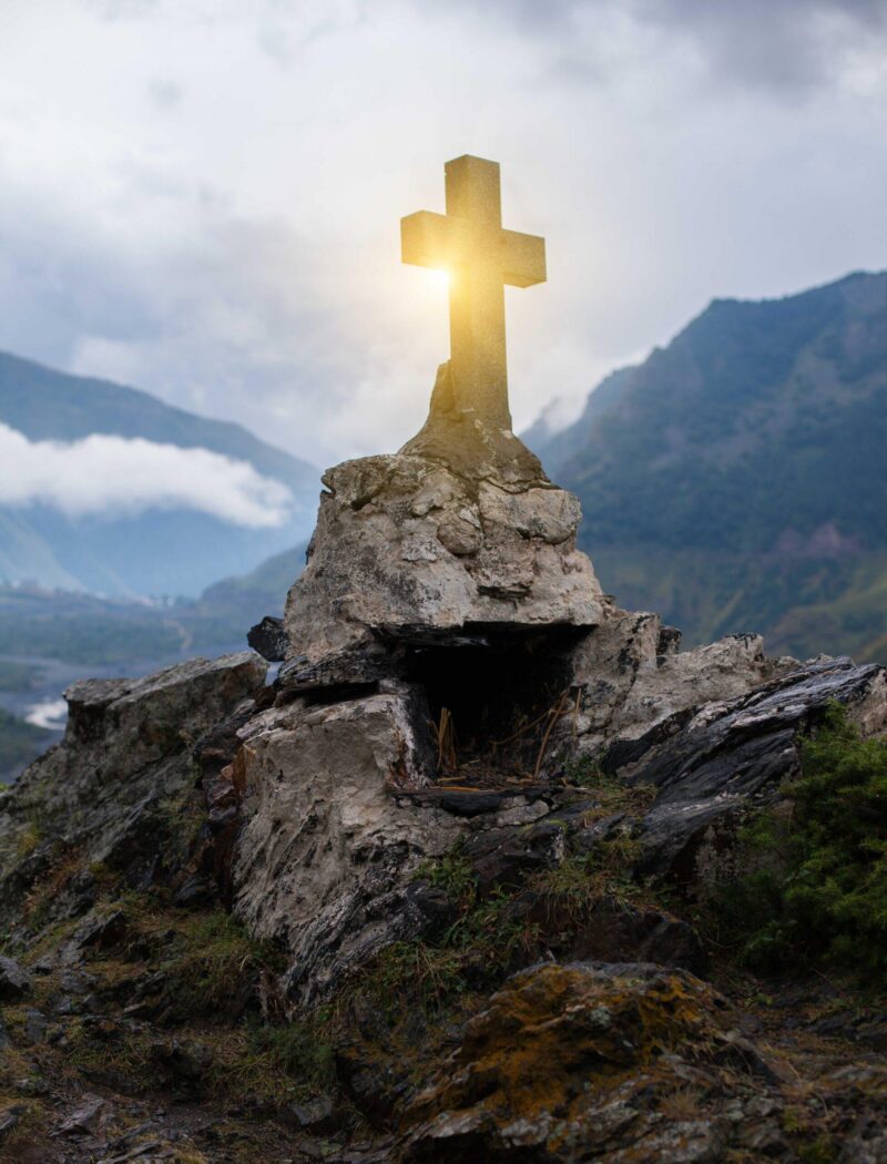 GEORGIA, KAZBEGI Orthodox cross near Caucasus mountains.