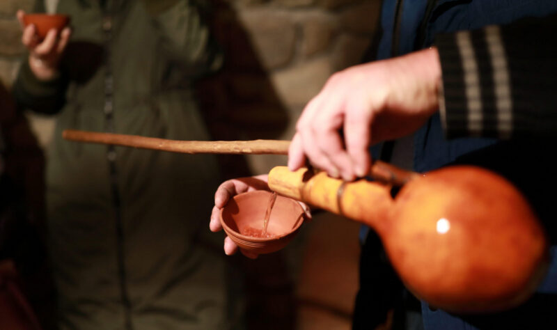 Man pouring white wine from Orshimo